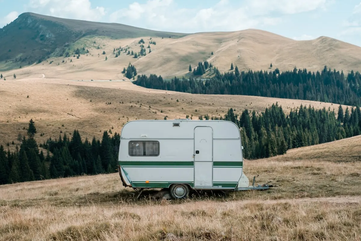 Old touring caravan standing in open countryside outside Amersham