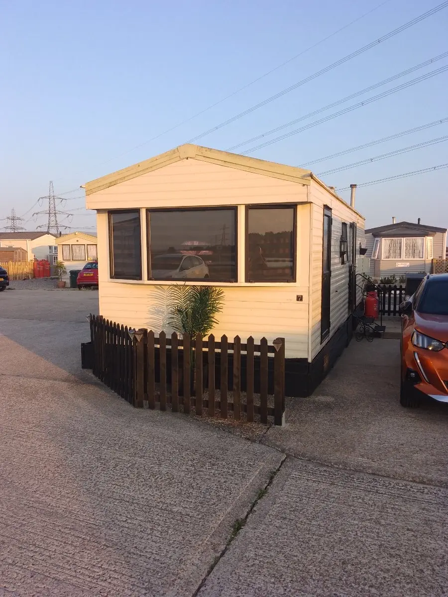 Cream static caravan on a fenced hard-standing pitch, the park and storage-site work covered across Basingstoke and Hampshire