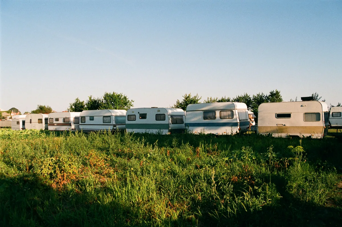 Caravans lined up on a rural storage plot near the Chiltern Hills