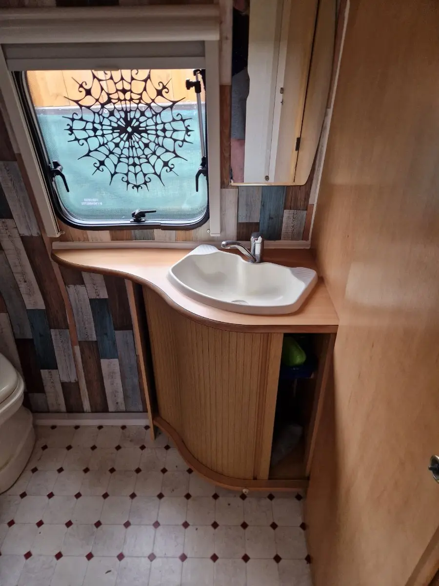 Touring caravan washroom with a moulded basin and vanity unit, an interior area photographs need to cover before an offer is confirmed