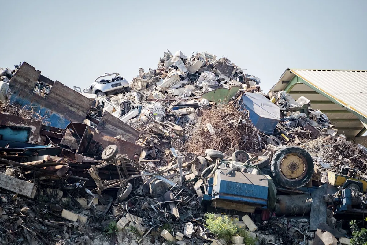 Sorted metal and mixed waste at a licensed recycling yard after caravan disposal